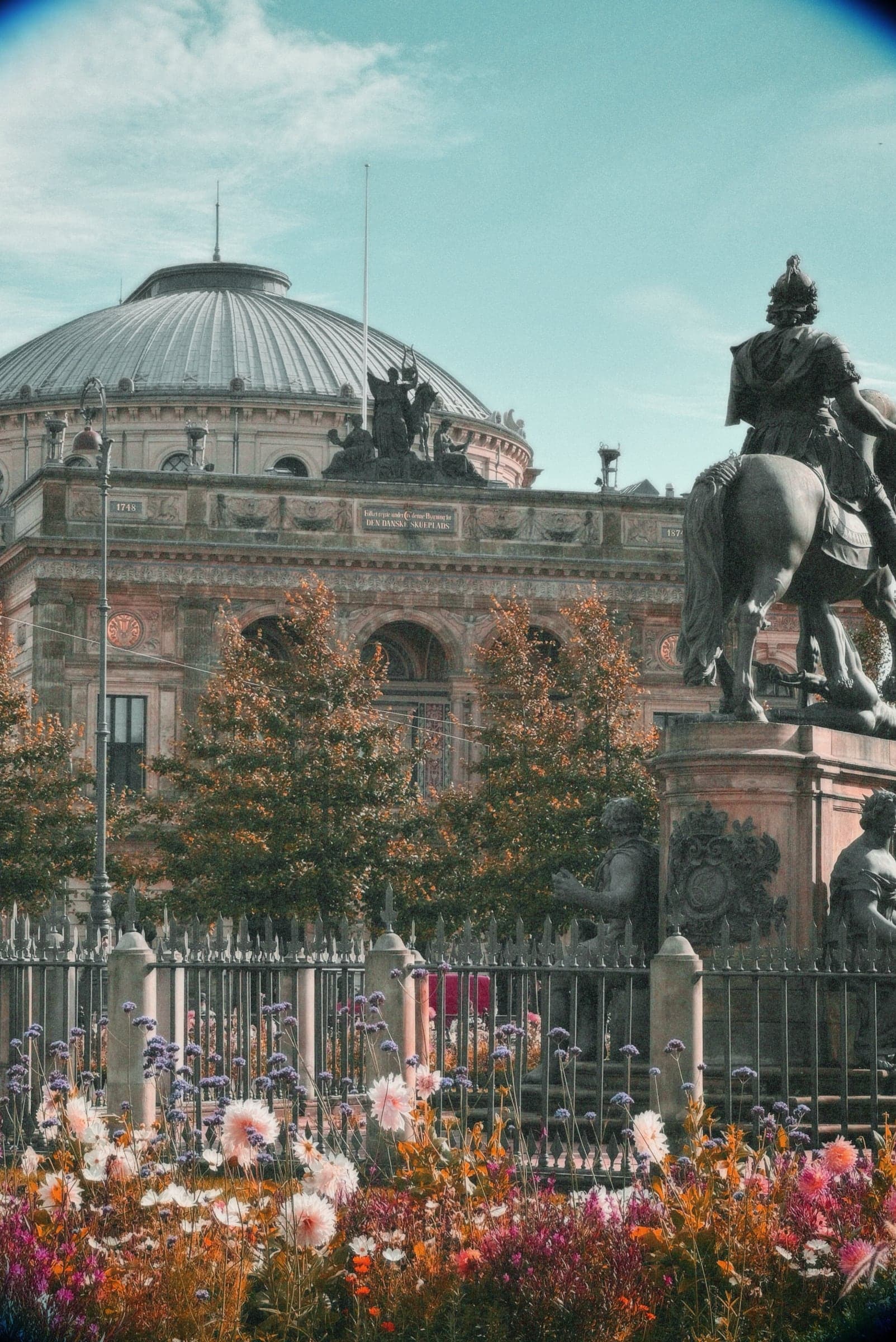 Equestrian statue and flowerbeds in front of a domed building, Copenhagen