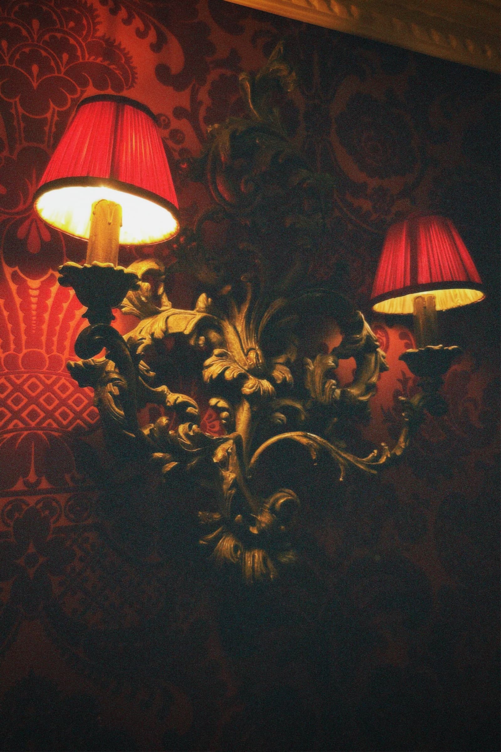 Red lamps on patterned wall, Rome